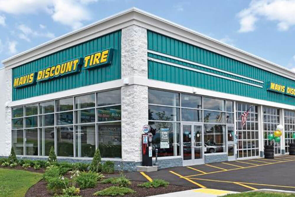 exterior of Mavis Discount Tire with teal and yellow signage